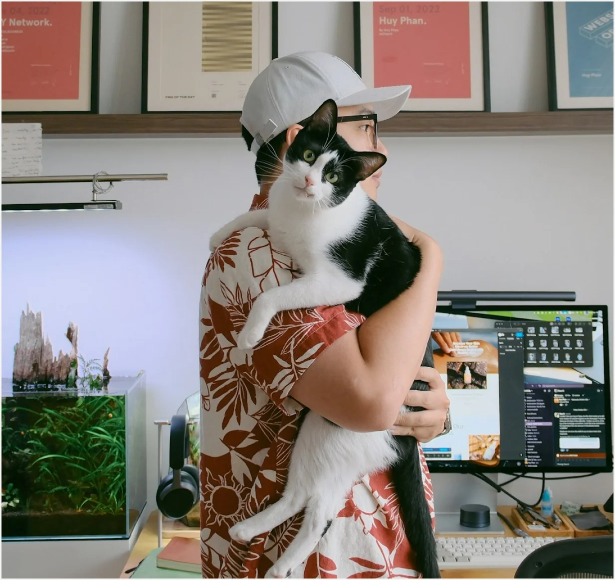 A team member holding a cat at their desk