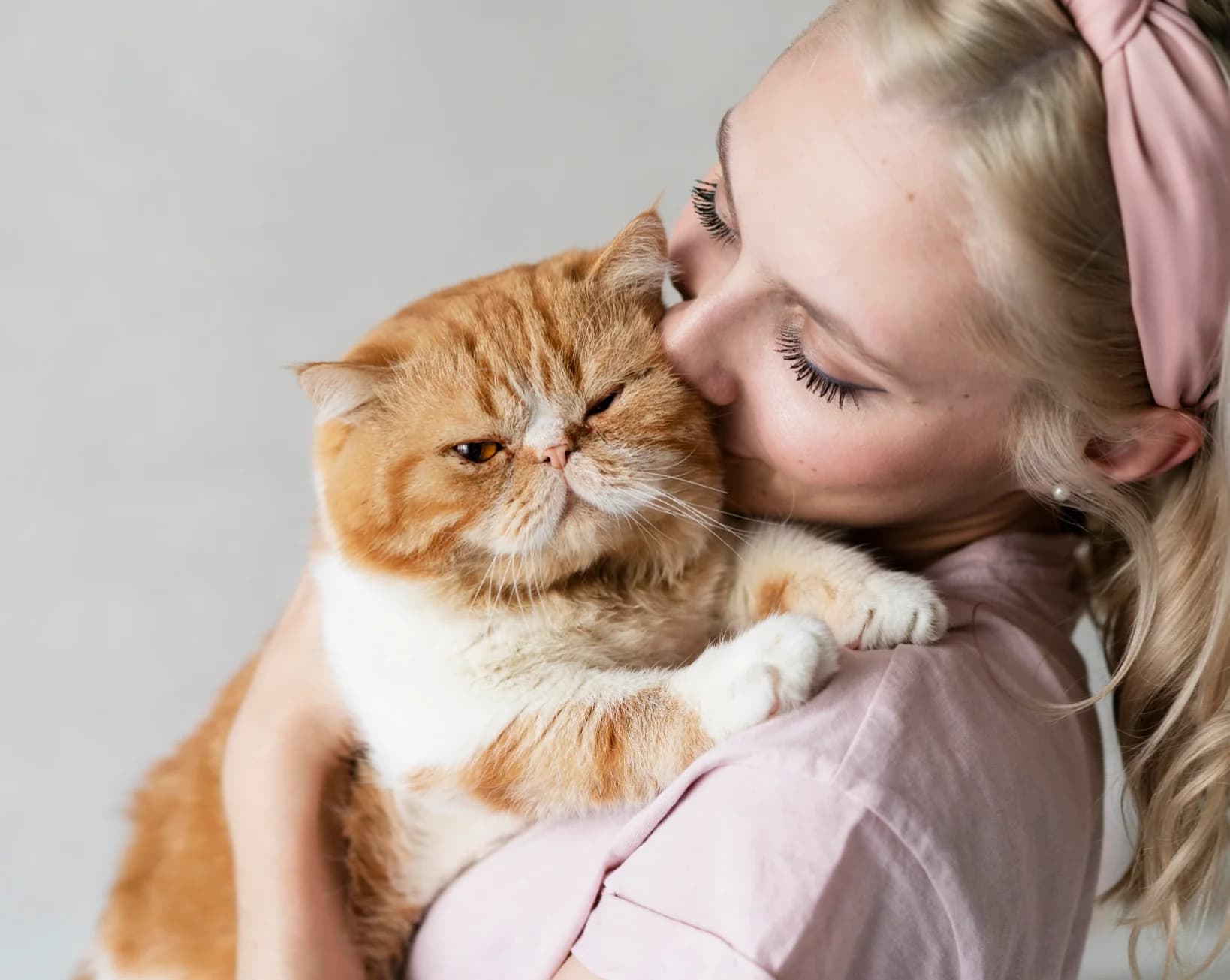 Woman holding an orange cat